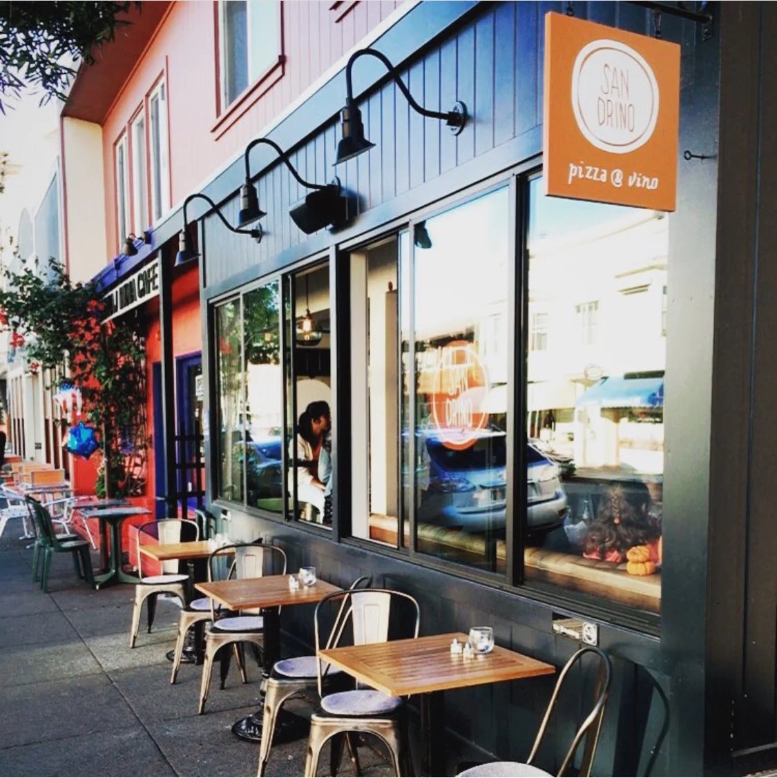 Sandrino storefront and outdoor tables on the Caledonia Street sidewalk
