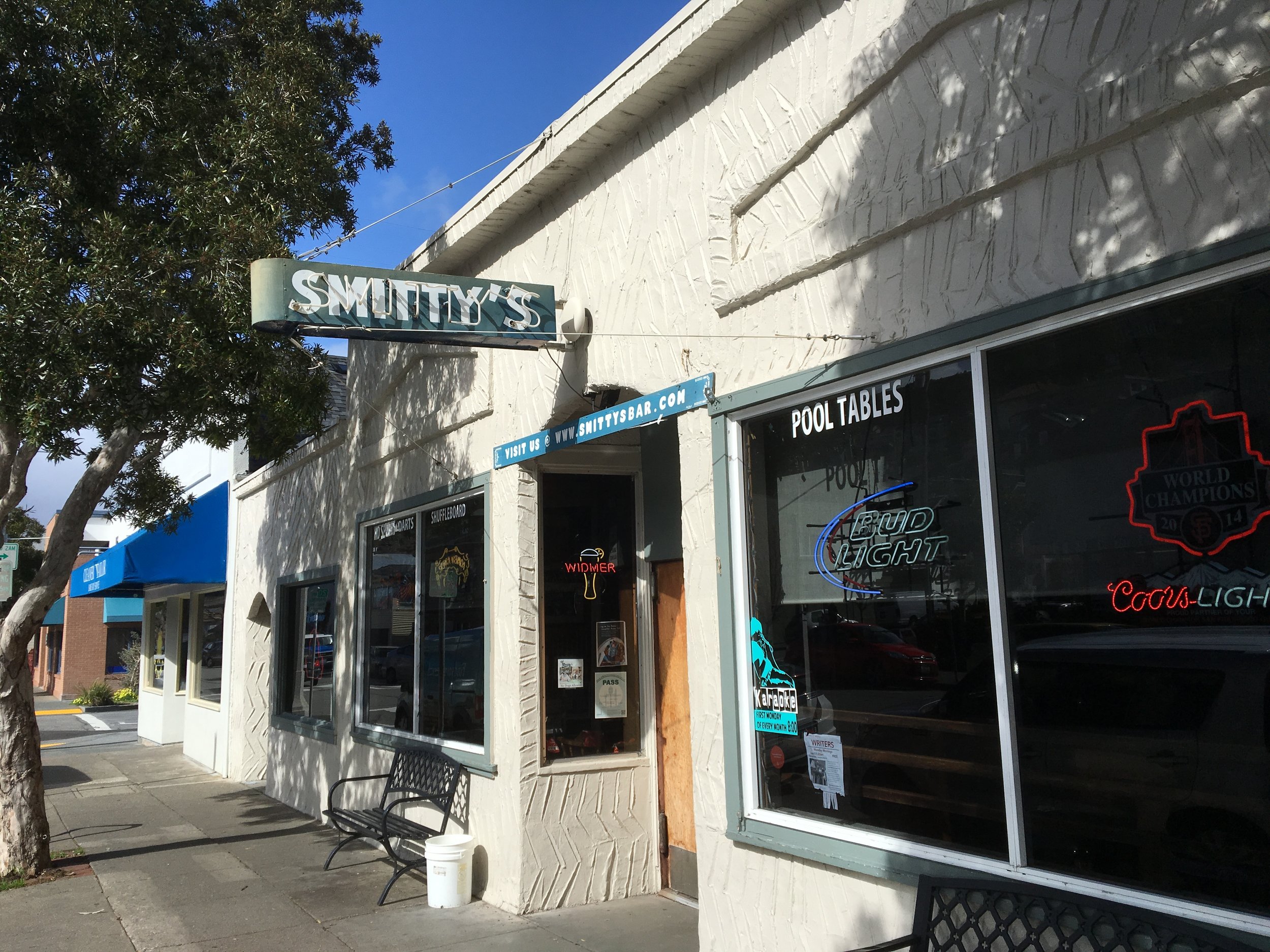 Smitty’s Bar façade and tree-lined Caledonia Street sidewalk