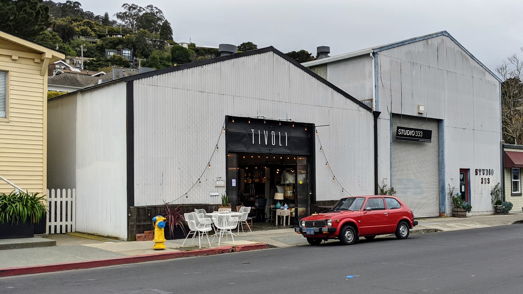 Tivoli Consignment’s white storefront, sidewalk display and Caledonia Street