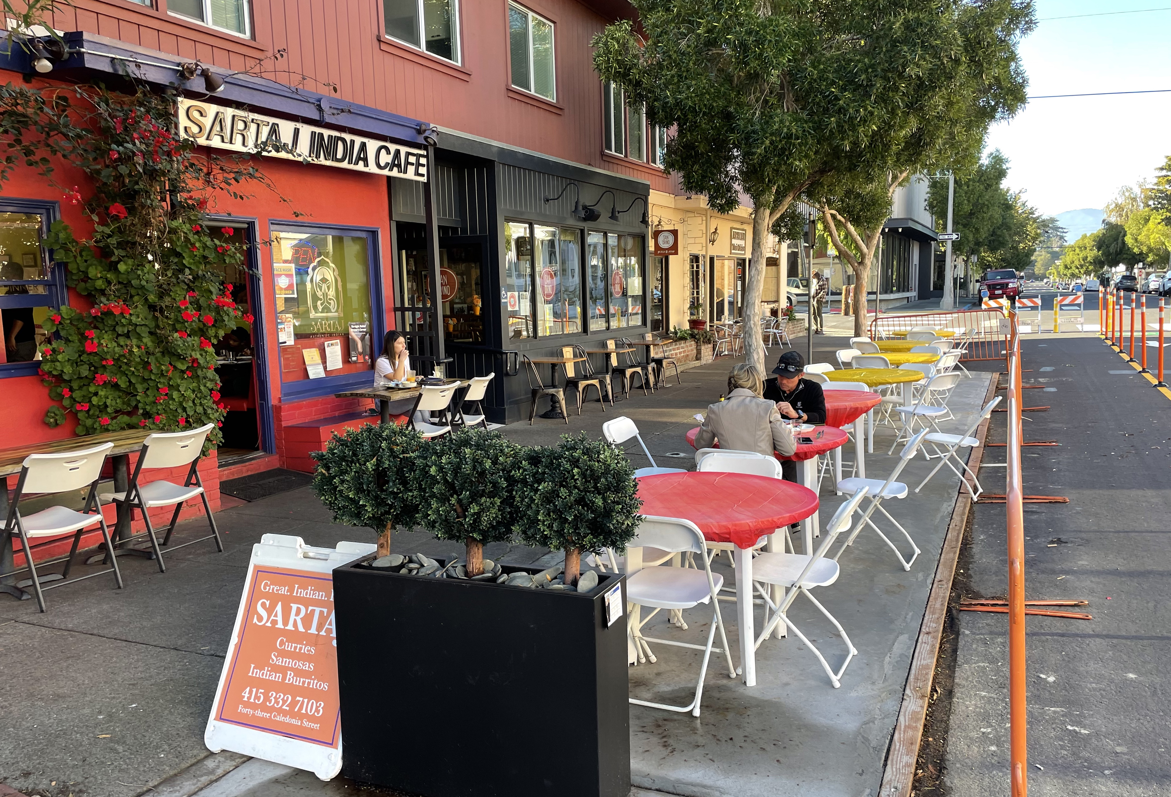 Neighbors dining outdoors along Caledonia Street
